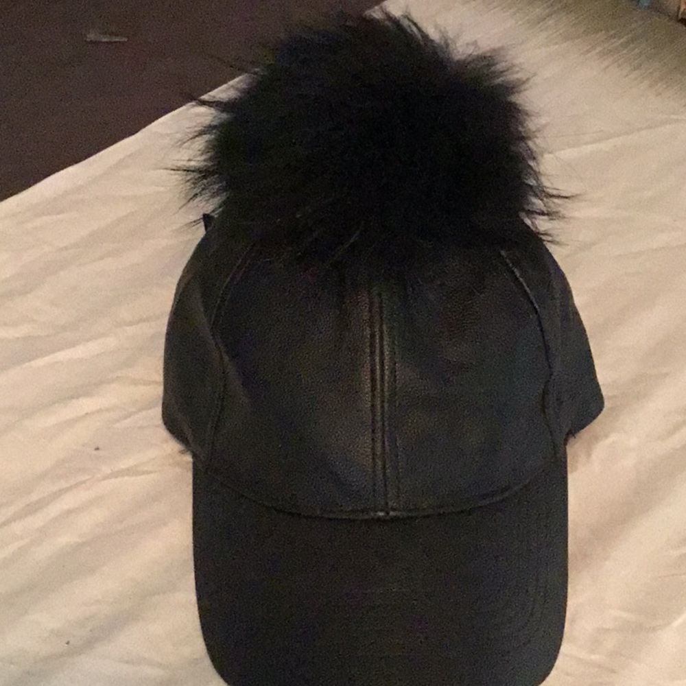 Black pom Pom on top of hat an adjustable back